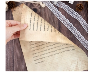 Detail view of vintage A4 paper showing thin texture on a rustic wooden surface