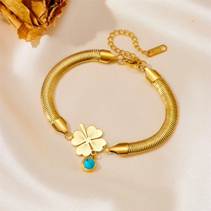 Golden stainless steel bracelet with engraved clover pendant and turquoise bead on satin