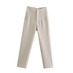 Detail view of high waist tailored trousers with side pockets and center creases in beige