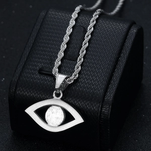 Silver hip hop necklace with evil eye pendant and gold-plated rope chain in macro view