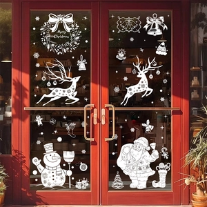 Close-up of white Merry Christmas window decals with Santa, deer, and snowflakes