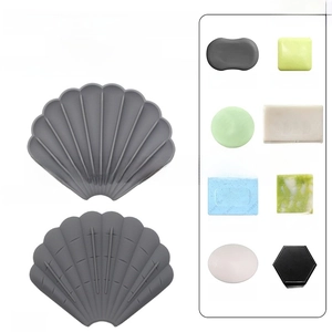 Shell-shaped silicone soap dish detail showing drainage ribs and multi-size compatibility