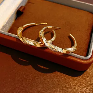 18K gold plated C-shaped twisted hoop earrings with zircon stones in a luxury style