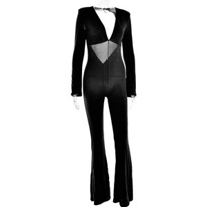 Detail of sheer mesh paneling and deep V-neck on a black long sleeve jumpsuit