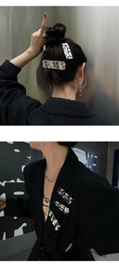 Detail showing silver metal hair clips with wrinkled foil texture on a bun hairstyle