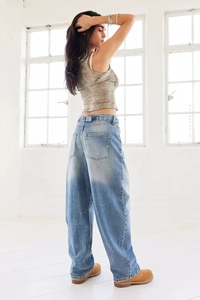 Detail showing the heavy washed vintage texture of loose wide-leg low-rise denim jeans