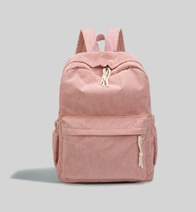 Detailed close-up of pink corduroy backpack featuring large front pocket and side pocket