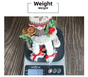 Christmas faceless gnome doll with knitted snowflake hat and skis shown on a scale