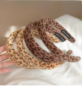 Detail of four handmade leopard print plush headbands with soft faux fur texture