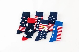 Detailed flat lay of six cotton socks featuring American flag and eagle patterns in patriotic colors