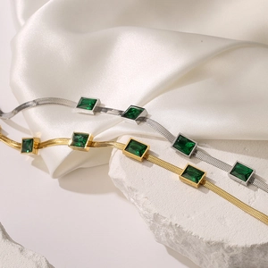 Flat snake bone chain necklace in gold and silver with square emerald green zircon stones