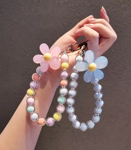 Detail of handmade beaded flower phone straps with pink and blue macaron colors