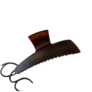 Matte dark brown large shark hair claw clip in a minimalist crescent shape for women