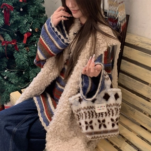 Close-up of vintage jacquard plush tote bag with fabric logo label on winter outfit