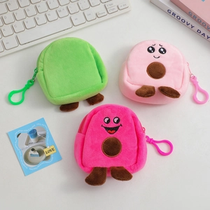 Three cute avocado plush coin purses in green and pink with hooks on a white desk