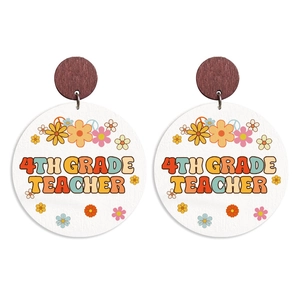 Close-up of wooden earrings with retro floral pattern and 4TH GRADE TEACHER text print