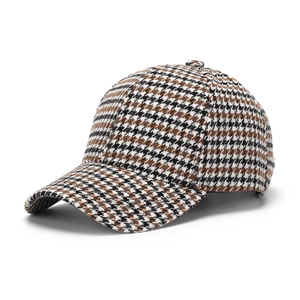 Detail of classic houndstooth baseball cap in brown and black wool-like fabric