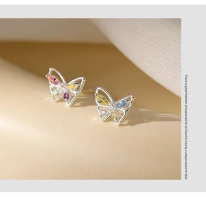 Detailed close-up of S925 silver butterfly stud earrings with colorful gemstones
