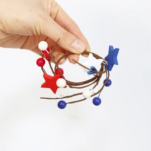 Close-up of red, white and blue patriotic star napkin ring with berry accents