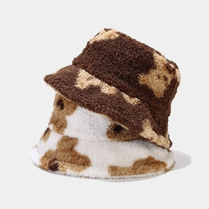 Winter plush bucket hat with cute bear pattern in dark brown and beige faux fur material