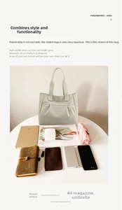 Flat lay of a large grey canvas tote bag showing its spacious storage capacity for daily items