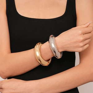 Minimalist thick metal geometric open bangle in gold and silver finish with high polish