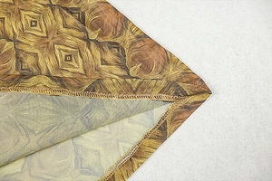 Close-up of brown geometric print fabric showing professional stitching and textile texture