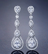 Detailed close-up of teardrop-shaped silver earrings with sparkling zircon stones