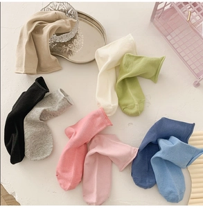 Detailed close-up of colorful cotton socks in various pastel shades for summer comfort