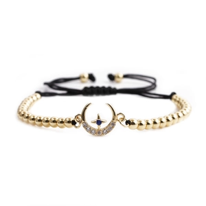 Adjustable gold bead bracelet featuring a crescent moon and star charm with blue stone