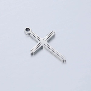 Polished stainless steel cross pendant with geometric engraved lines on metallic background