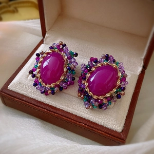 Vintage oval purple crystal earrings with gold weaving in a jewelry box