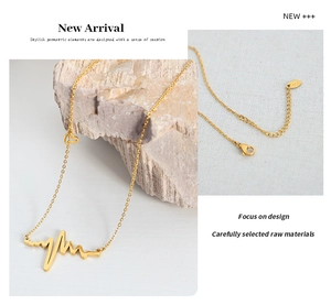 Detail of gold heartbeat pendant necklace with adjustable lobster clasp and heart charm