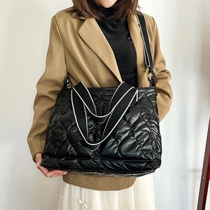 Waterproof quilted tote bag with black and white striped shoulder strap for women