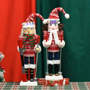 Skiing Nutcracker wood soldier ornaments with red hats and scarves for Christmas decor