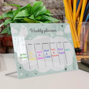 Detail view of transparent acrylic weekly planner board with bear design and metal supports