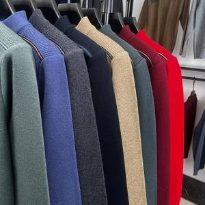 Selection of premium men's half-zip knit sweaters in various colors on display