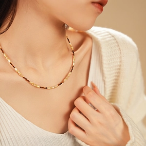 Gros plan d'un collier de perles en nacre fleurie de style vintage français sur un mannequin