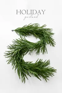 Detailed view of dark green Norfolk pine garland for festive holiday table decoration