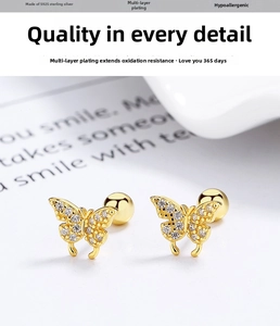 Macro shot of 925 silver gold-plated butterfly stud earrings with sparkling cubic zirconia