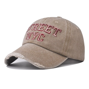 Detail of distressed khaki baseball cap featuring 3D STREET NYC embroidery in retro style