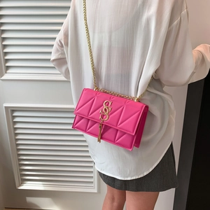 Fashionable rose pink quilted chain crossbody bag with golden hardware and tassel detail
