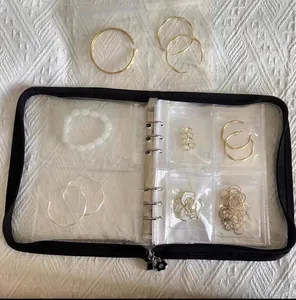 Detail view of black zipper jewelry binder with clear loose-leaf PVC storage pockets