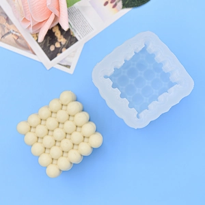 3D bubble cube silicone mold for DIY candles and plaster crafts on blue background