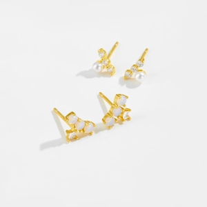 Close-up of S925 silver stud earrings with pearls, zircons and opal stones in gold plating