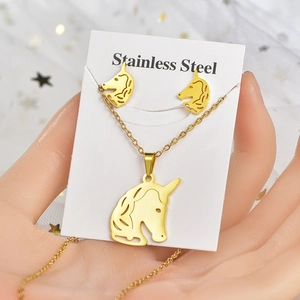 Golden unicorn necklace and earrings set made of stainless steel on card display