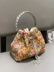 Detail of colorful crystal bucket bag with rhinestone ring handle and tassel drawstring