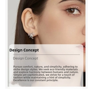 Detailed close-up of a 925 sterling silver bow earring on a model for a chic French style