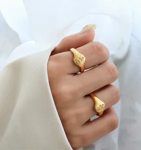 Macro detail of gold-plated 18k rings featuring artistic rose and female face relief design