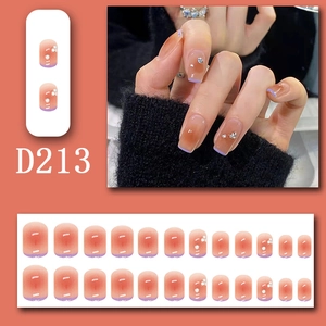 Detail of orange to purple gradient press-on nails with white patterns in D213 style
